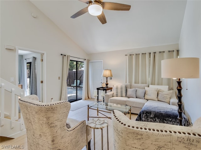 living room featuring light hardwood / wood-style floors, ceiling fan, and high vaulted ceiling