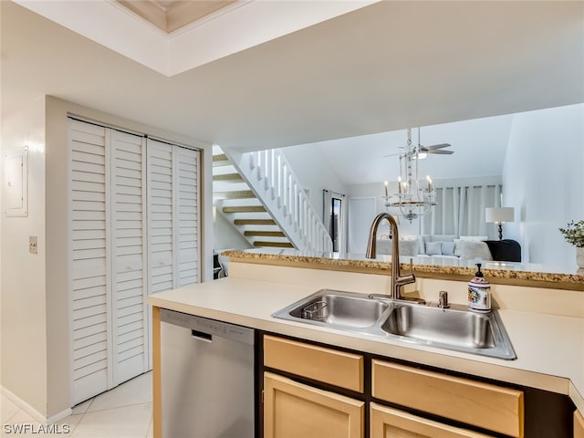 kitchen with sink, pendant lighting, light tile floors, stainless steel dishwasher, and ceiling fan with notable chandelier