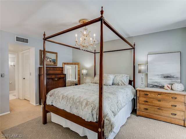 carpeted bedroom with an inviting chandelier