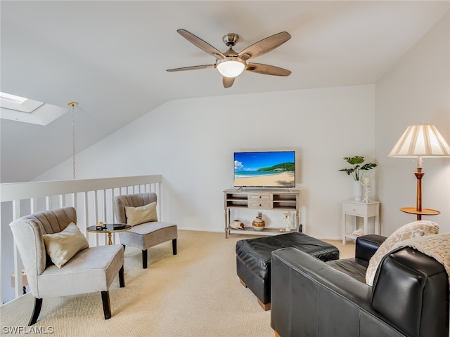 carpeted living room featuring lofted ceiling with skylight and ceiling fan