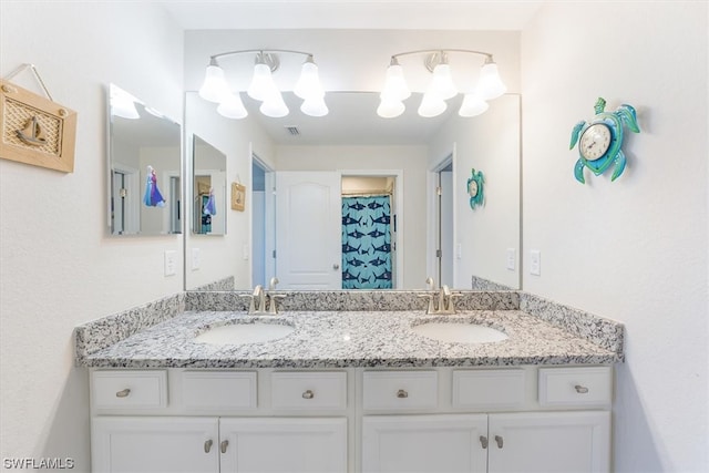 bathroom with oversized vanity and dual sinks