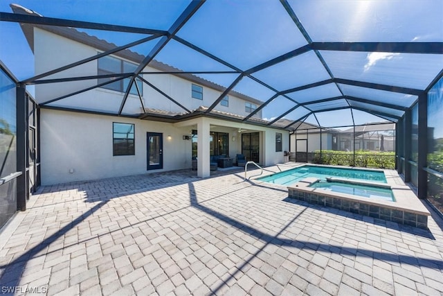 view of swimming pool with a patio area, an in ground hot tub, and glass enclosure