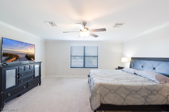 carpeted bedroom featuring crown molding and ceiling fan