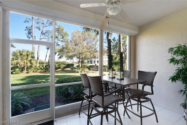 sunroom / solarium featuring ceiling fan