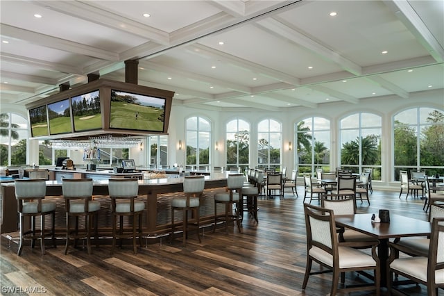 bar with coffered ceiling, plenty of natural light, dark hardwood / wood-style floors, and beamed ceiling