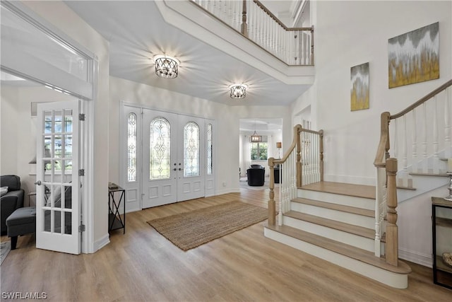 foyer entrance featuring french doors and wood-type flooring