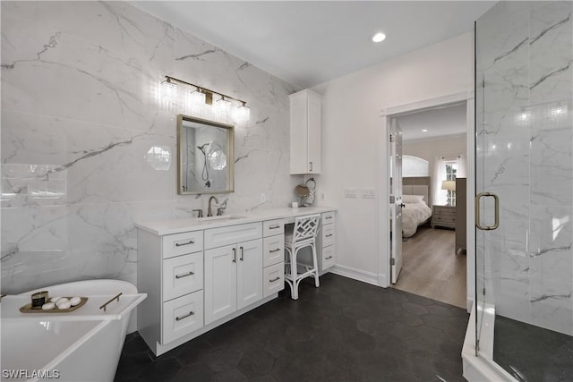 bathroom featuring separate shower and tub, tile patterned floors, vanity, and tile walls