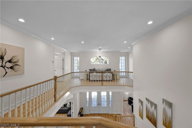 hallway with french doors, ornamental molding, and hardwood / wood-style floors