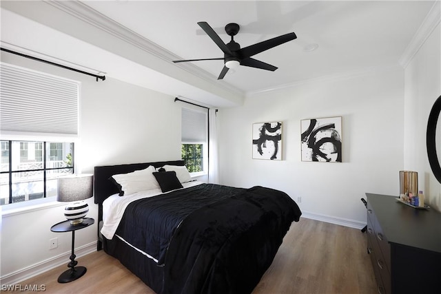 bedroom featuring ceiling fan, crown molding, and light hardwood / wood-style floors