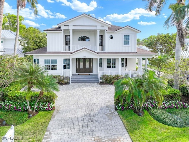 view of front of property featuring french doors and a balcony