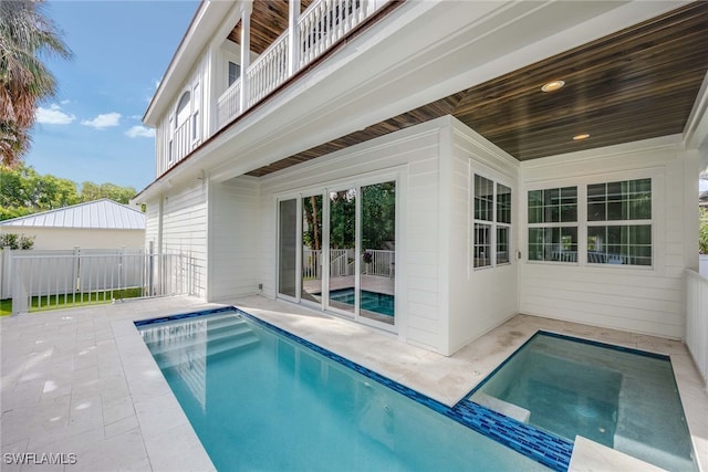 view of pool featuring a patio and a hot tub