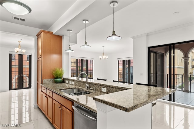 kitchen featuring dishwasher, sink, a chandelier, and decorative light fixtures