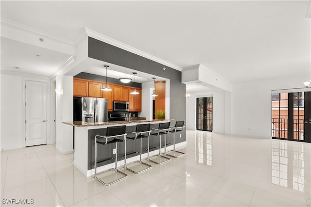 kitchen with kitchen peninsula, decorative light fixtures, a kitchen bar, light tile patterned floors, and appliances with stainless steel finishes