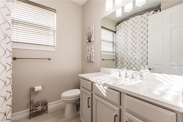 bathroom with vanity, hardwood / wood-style floors, and toilet