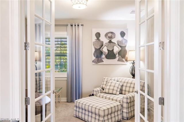 living area with light colored carpet and french doors