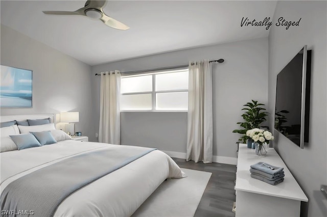 bedroom featuring ceiling fan and dark wood-type flooring