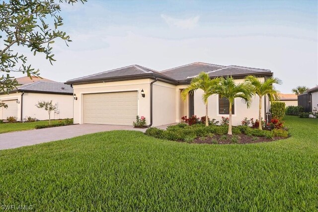 view of front of home featuring a front lawn and a garage