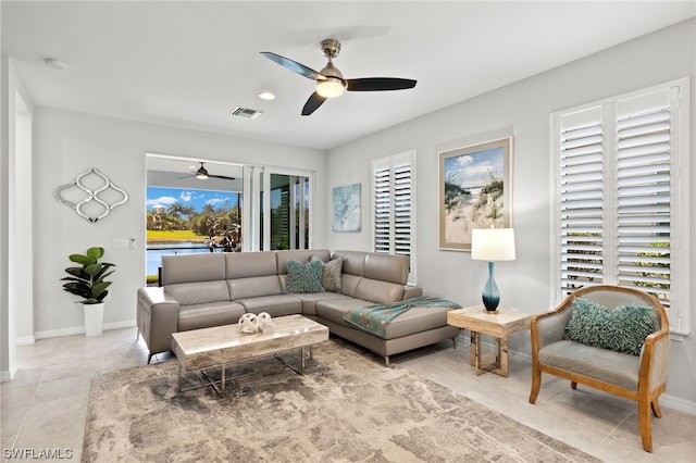 living room with light tile patterned floors and ceiling fan