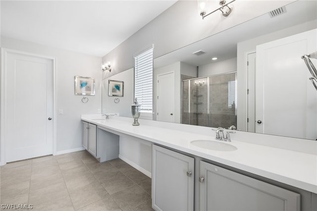 bathroom with vanity, an enclosed shower, and tile patterned floors