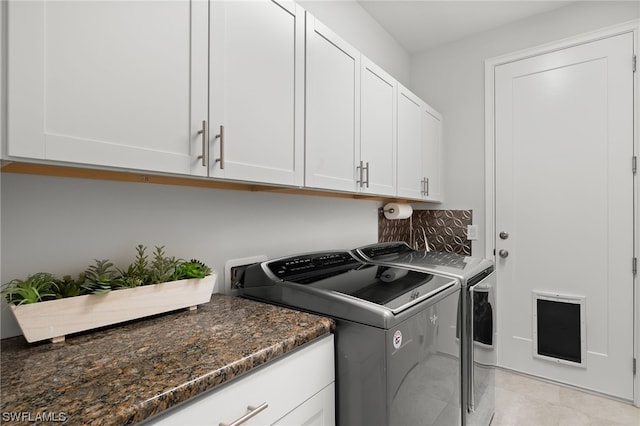 washroom with separate washer and dryer and cabinets