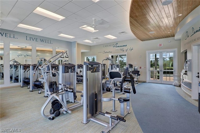 exercise room with french doors, light colored carpet, ceiling fan, and wooden ceiling