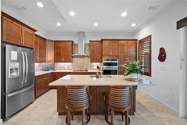 kitchen featuring a kitchen island with sink, stainless steel appliances, light tile flooring, wall chimney exhaust hood, and tasteful backsplash