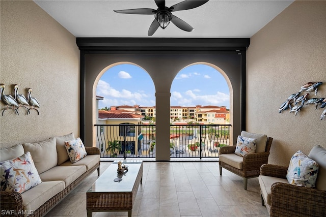 living room featuring light tile flooring and ceiling fan