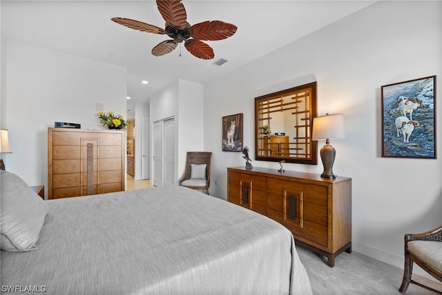 bedroom featuring light carpet, a closet, and ceiling fan