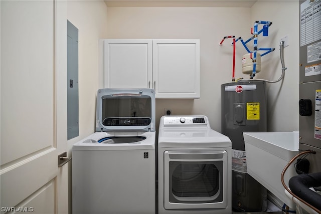 laundry area featuring water heater, cabinets, and washer and clothes dryer