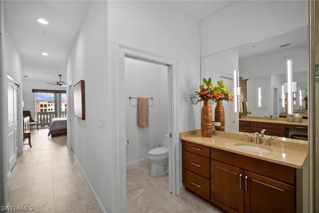 bathroom featuring tile floors, toilet, vanity, and ceiling fan