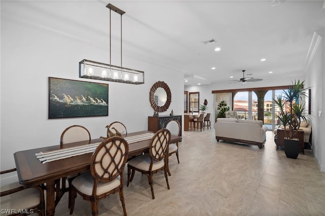 tiled dining area featuring ceiling fan with notable chandelier and ornamental molding