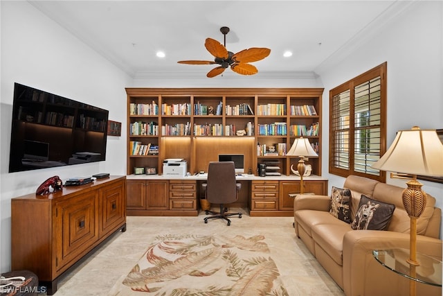 office with ornamental molding, ceiling fan, and built in desk