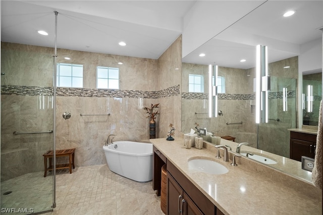 bathroom featuring vanity, tile flooring, shower with separate bathtub, and tile walls