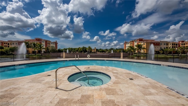 view of swimming pool with a community hot tub