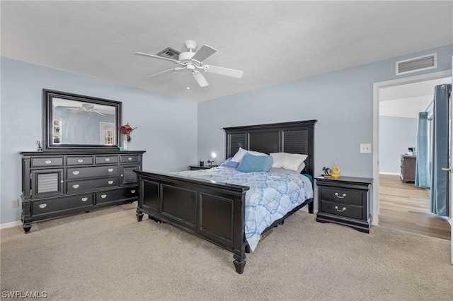 bedroom featuring light colored carpet and ceiling fan