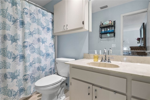 bathroom with tile patterned floors, vanity, and toilet