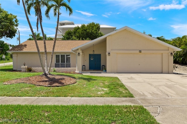 ranch-style home with a garage and a front lawn