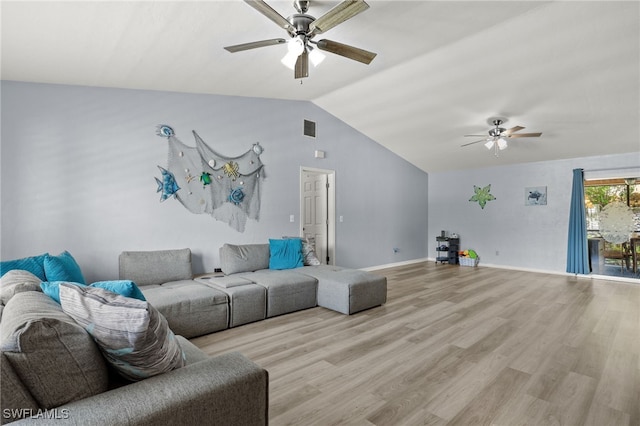 living room with ceiling fan, light hardwood / wood-style floors, and vaulted ceiling