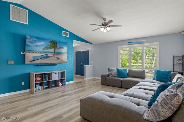 living room with light hardwood / wood-style floors, ceiling fan, and lofted ceiling