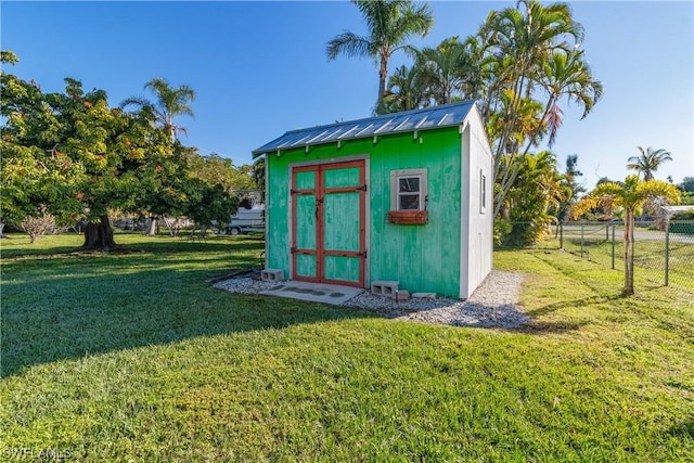 view of outbuilding featuring a lawn