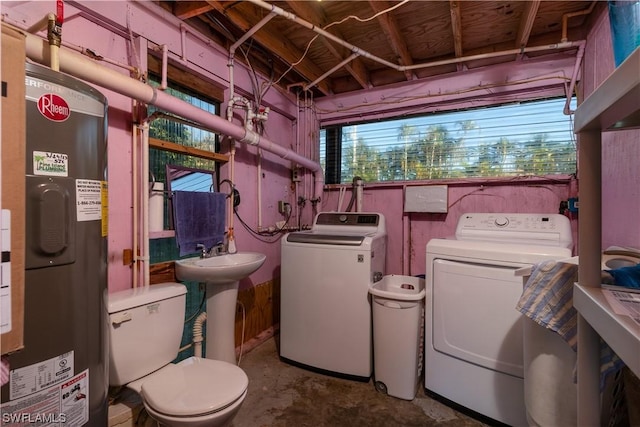 clothes washing area with separate washer and dryer, electric water heater, and sink