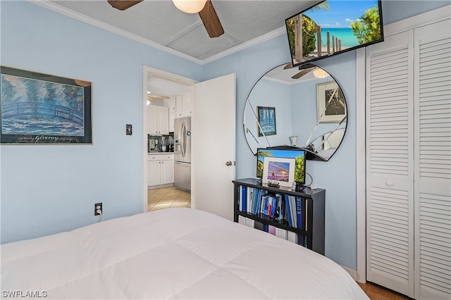 bedroom with stainless steel fridge with ice dispenser, ceiling fan, a textured ceiling, and ornamental molding