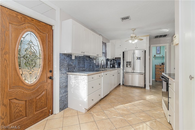 kitchen with dishwasher, sink, stainless steel refrigerator with ice dispenser, backsplash, and white cabinets