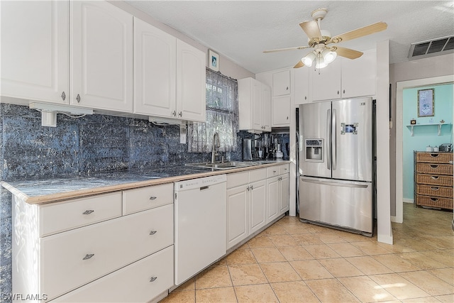 kitchen with dishwasher, white cabinets, sink, stainless steel refrigerator with ice dispenser, and light tile patterned floors