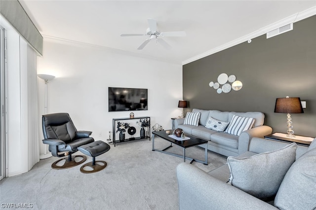 carpeted living room featuring ornamental molding and ceiling fan