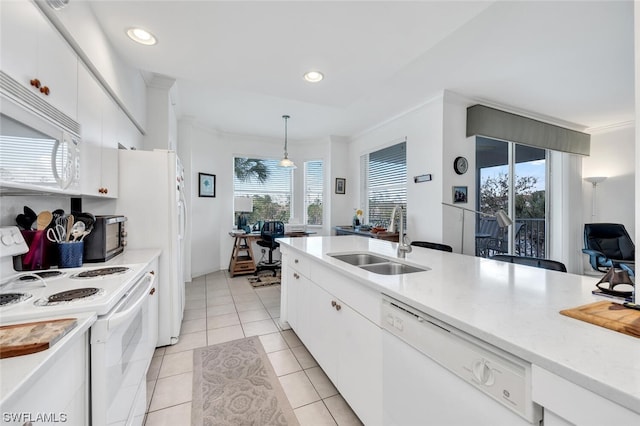 kitchen with light tile floors, decorative light fixtures, white appliances, white cabinetry, and sink