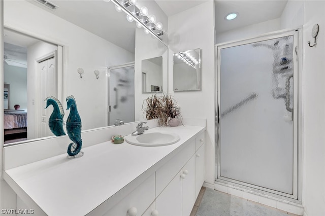 bathroom featuring tile floors, an enclosed shower, and vanity