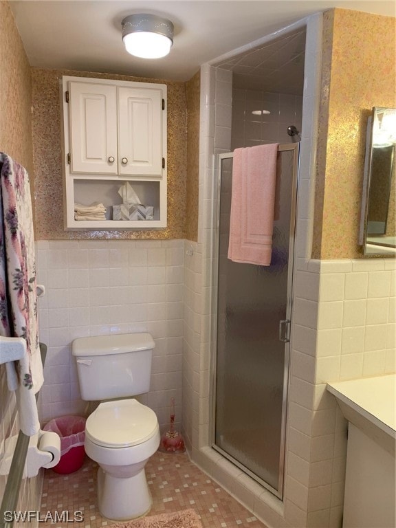 bathroom with vanity, tile flooring, a shower with shower door, and toilet