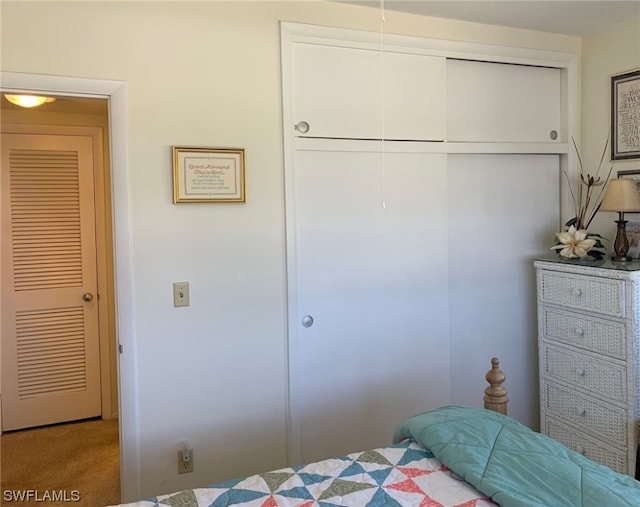 carpeted bedroom with a closet