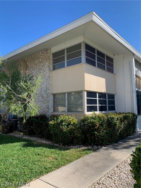 view of property exterior with a yard